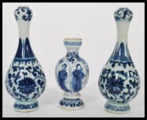 A pair of early 20th century Chinese blue and white vases having hand painted decoration of floral