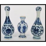 A pair of early 20th century Chinese blue and white vases having hand painted decoration of floral