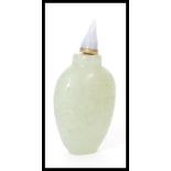 A 19th century Chinese jade scent / perfume bottle of typical form having incised decoration.
