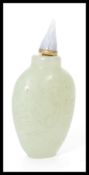 A 19th century Chinese jade scent / perfume bottle of typical form having incised decoration.