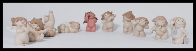 A group of Nao ( LLadro ) cherubs figurines in various poses. All stamped for Nao. (10) Measures