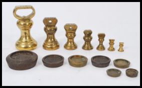 A group of vintage early 20th century weights to include a graduating set of bell weights and
