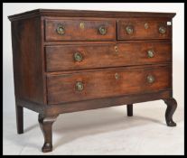 An 18th century mahogany chest of drawers being raised on cabriole legs with a series of 2 short