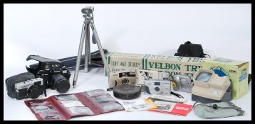 A collection of vintage cameras and tripods to include a 35mm Japanese camera Cosina CT1 Super