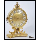 A vintage 20th century Junghans Meister brass cased mantel clock having a gilt dial with faceted