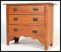 An early 20th Century Edwardian satin wood cottage chest of three graduating three drawers, swag