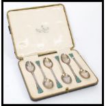 A set of six silver hallmarked and enamel teaspoons having acorn and leaf terminal handles with