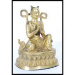 A 19th century gilt bronze statue of a Buddha raised on pedestal base with scrolled robe and