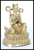 A 19th century gilt bronze statue of a Buddha raised on pedestal base with scrolled robe and