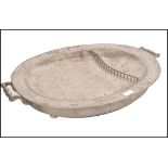 A 19th century pewter Victorian hot water large meat platter of oval form having twin handles with a