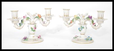 A pair of Dresden porcelain double sconce candelabras, each decorated with applied ceramic flowers