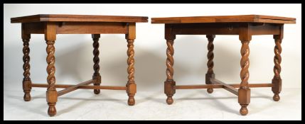 A 1930's oak barleytwist draw leaf dining table being raised on barley twist legs with fitted frieze