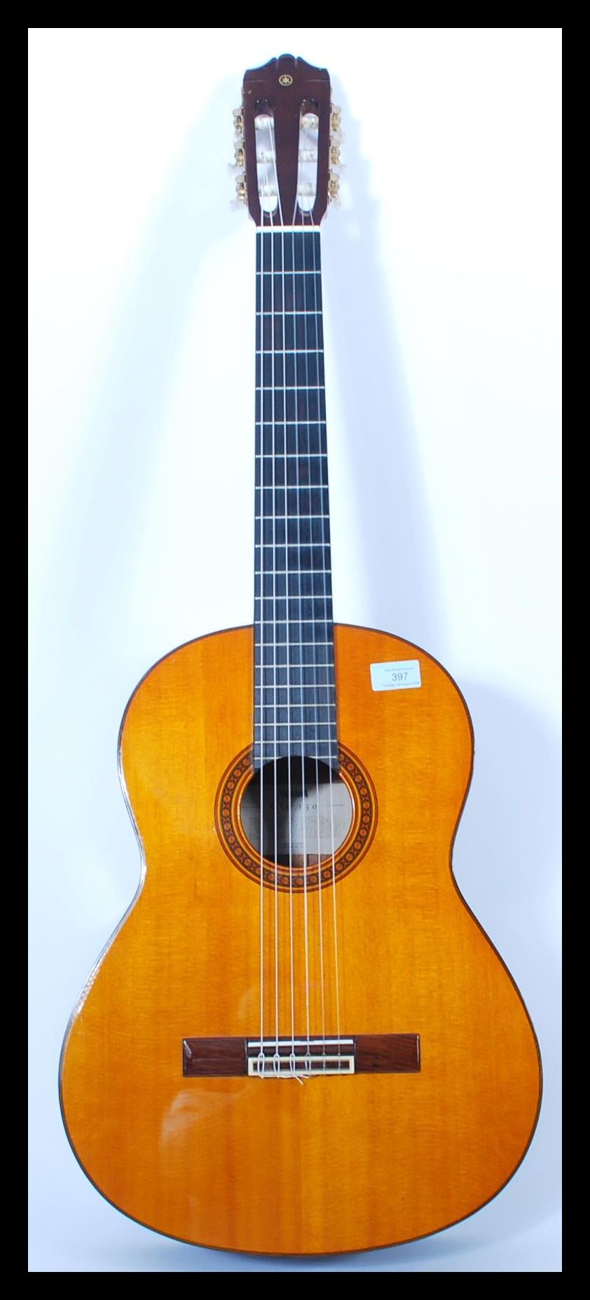 A vintage Yamaha six string acoustic guitar model CG 130 having a shaped hollow body with mother