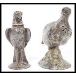 A pair of 20th century novelty desk/ mantelpiece salts in the form of birds - one being a falcon.