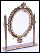 A 19th century brass mirror raised on plinth base with columns and scrolled floral border.