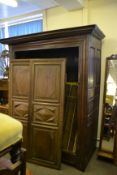 An 18th century carved oak French armoire wardrobe   being raised on shaped legs with twin carved
