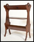 A 19th century Victorian Arts and Crafts oak bookstand trough magazine Canterbury having three tiers