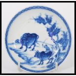 A 19th century Chinese blue and white shallow bowl dish having hand painted decoration of farmer and