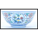 A 19th century Chinese bowl having hand painted five colour decoration depicting traditional scenes.
