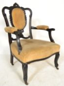 A late Victorian ebonised mahogany salon armchair. Yellow velour overstuffed seat and elbow