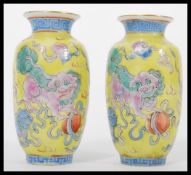 A pair of 19th century Canton Enamel Chinese miniature vases having a famille Juan ground with