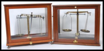 2 sets of early 20th century scientific cased scales to include a bakelite based example by
