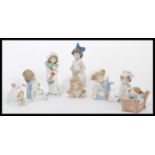 A group of Nao ( Lladro ) ceramic  figurines of children to include child sleeping in bed, child