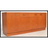 A retro 20th century G - Plan Fresco teak wood low sideboard having an arrangement of drawers and