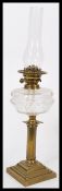 A 19th century Victorian brass and glass oil lamp having a fluted column base with cut glass