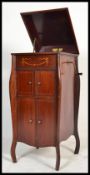 An early 20th century Fullotone floor standing gramophone with hinged lid to the cabinet and box
