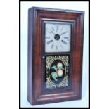 A vintage 20th century American wall clock having a rectangular mahogany veneered case with white