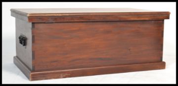 A large 20th Century hard wood blanket box, exposed dovetail detailing, hinged lid with drop handles