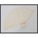 A vintage early 20th century Chinese bone hand fan having 32 panels pierced depicting geometric