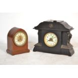 A Victorian slate large 8 day mantel clock with carved masks to the sides, decorative dial