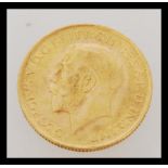 An early 20th century George V full sovereign gold coin dated 1928. Weighs 7.98 grams.