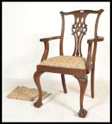 A 19th century carved mahogany Chippendale revival carved carver armchair. The pierced vase back