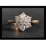 A hallmarked 9ct gold and diamond cluster ring. Di