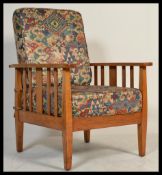 A 1930's Art Deco golden oak stick back armchair. Raised on squared legs with flat plank arm rests