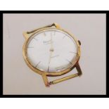 A vintage 20th century 14ct gold incabloc watch by Royce having a silvered dial with baton