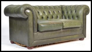 A good 20th century two setter leather button back Chesterfield sofa settee. Raised on bun feet with