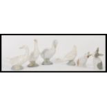 A group of Nao ( Lladro ) figures of animals to include four geese and two rabbits. Please see