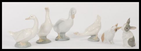 A group of Nao ( Lladro ) figures of animals to include four geese and two rabbits. Please see