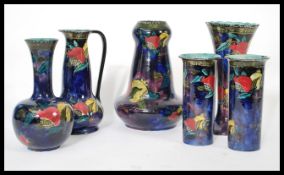 A group of six Ruben ware lustre ceramics to include vases and bowls. Makers stamps to bases.