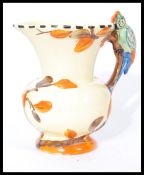 A vintage Wade Heath woodpecker handled jug having hand painted details with makers marks to base.