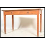 A vintage retro mid 20th century beech FSA desk having twin drawers raised on tapering square