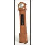 A vintage early 20th century oak cased granddaughter clock by Enfield. The silvered dial with