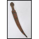 A 19th century Mongolian ceremonial dress dagger having a copper handle and sheaf with inset coral