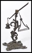 A 19th century rare bronze letter scale of unusual form raised on a scrolled base. Please see