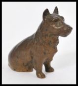 A 19th century Victorian bronze figurine of a terrier dog modelled in a seated position. Measures
