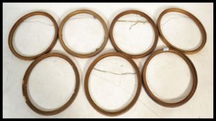 A set of seven early 20th century gilt oval picture frames. Please see images. Measures 44 cm x 38